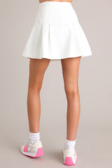 Back view of this skort that features a high waist, a zipper down the side, pleated detail, and built in shorts.