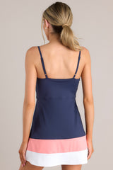 Back view of this dress that features a rounded neckline, thin adjustable straps, a built-in shelf bra, built-in shorts with functional pockets, and a color blocked hemline.
