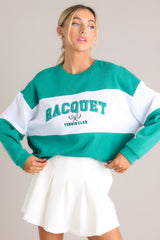 Front view of this sweatshirt that features a ribbed crew neckline, high contrast color blocking, embroidered & terry cloth wording, ribbed cuffed sleeves, and a ribbed hemline.