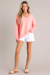 Full body view of this sweatshirt that features a v-neckline, a soft material, a split hemline, and ribbed cuffed sleeves.