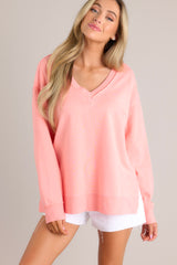 Full front view of this sweatshirt that features a v-neckline, a soft material, a split hemline, and ribbed cuffed sleeves.
