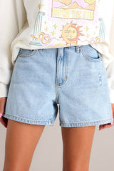 Front view of these denim shorts that feature a high waist, classic button-zipper closure, functional belt loops, and five pockets.