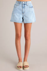 Full front view of these denim shorts that feature a high waist, classic button-zipper closure, functional belt loops, and five pockets.