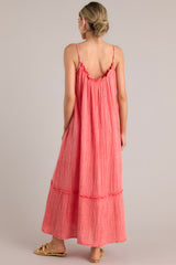 Back view of this coral midi dress that features a gauze cotton fabric, adjustable straps, and a tiered skirt.