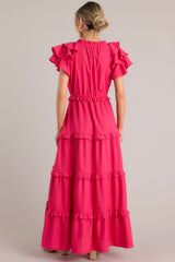 Back view of this dress that features a v-neckline with a self-tie closure, ruffled flutter sleeves, a drawstring waistband, and a long, flowy skirt.