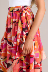 Close up view of this skirt that features a high-waist design and a self-tie wrap around belt.