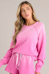 This pink sweatshirt features a crew neckline, a super soft material, an ombre design, and ribbed cuffed sleeves.