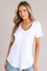 This all white jersey tee features a curved v-neckline, raw edge breast pocket, short sleeves, and scoop hem.