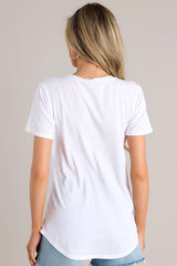 Back view of  this jersey tee that features a curved v-neckline, raw edge breast pocket, short sleeves, and scoop hem.