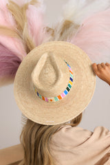 This palm hat features a multicolor cotton woven band, and is handmade with palm fronds.
