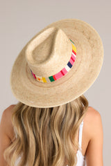 Top view of this hat that features a cotton woven band with vibrant colors, and is handmade with palm fronds.