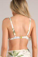 Back view of this bikini top that features a v-neckline, thick adjustable straps, removable padding, a wooden circle detail, and a functional clasp in the back.