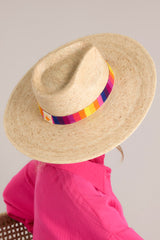 This palm hat features a cotton woven band with multicolor polka dots, and is handmade with palm fronds.