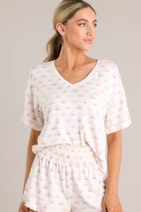 Front view of this white top featuring a v-neckline, a sun print, short sleeves, and a cozy lightweight fabric.