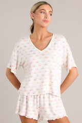 White sun print top with a v neckline and short sleeves.