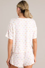 Back view of this white top featuring a v-neckline, a sun print, short sleeves, and a cozy lightweight fabric.