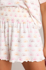 Close up detailing of the smocked waistband on these white, sun print pajama shorts. 