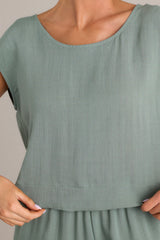 Close up view of this top that features a rounded neckline, a lightweight material, and wide short sleeves.