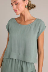 Front view of this top that features a rounded neckline, a lightweight material, and wide short sleeves.
