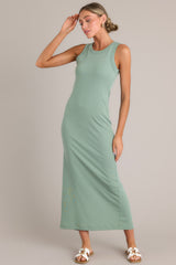 Angled view of  this dress that features a scoop neckline, a slit in the back and, a super soft material.