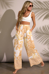These mustard print pants feature a high waist design, an elastic insert in the back of the waist, a functional zipper and button closure, belt loops, functional pockets, and a wide leg.