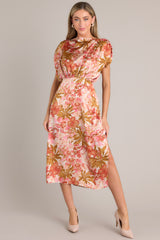 Front view of this knee-length rose pink dress with a boat neckline, gathered waist, elastic insert in the back, discreet side zipper, side slit, and wide sleeves.