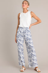 Full view of these pants that feature a high waisted design, an elastic waistband, functional hip pockets, a unique pattern, and a wide leg design.
