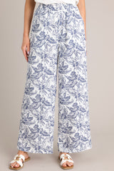 Front view of these pants that feature a high waisted design, an elastic waistband, functional hip pockets, a unique pattern, and a wide leg design.