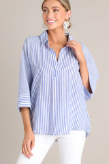 Front view of this collared top that features a v-neckline, three-quarter length sleeves, and a subtle pleat in the back.