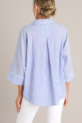 Back view of this collared top that features a v-neckline, three-quarter length sleeves, and a subtle pleat in the back.