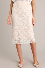 This beige midi skirt features a high waisted design, an elastic waistband, and a delicate lace overlay.