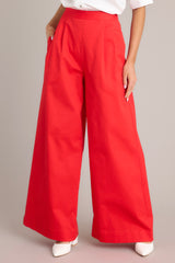 Front view of these pants that feature a high waisted design, an elastic insert, a discrete side zipper, subtle pleats, functional hip pockets, faux back pockets, and a thick hemline.