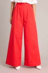 Full front view of these pants that feature a high waisted design, an elastic insert, a discrete side zipper, subtle pleats, functional hip pockets, faux back pockets, and a thick hemline.