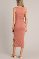 Back view of this terracotta midi bodycon dress with ruching on both sides of the waist and a slit up the leg.