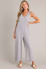 Full front view of this jumpsuit that features a v-neckline, a lightweight material, a wide leg, and a slightly cropped hemline.