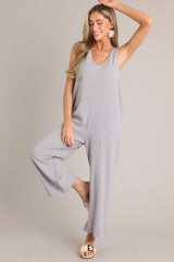 Full body view of this jumpsuit that features a v-neckline, a lightweight material, a wide leg, and a slightly cropped hemline.