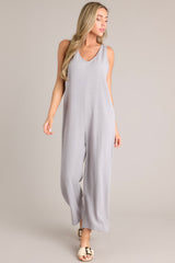 Front view of this jumpsuit that features a v-neckline, a lightweight material, a wide leg, and a slightly cropped hemline.