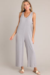 Full view of this jumpsuit that features a v-neckline, a lightweight material, a wide leg, and a slightly cropped hemline.