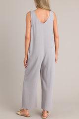 Back view of this jumpsuit that features a v-neckline, a lightweight material, a wide leg, and a slightly cropped hemline.