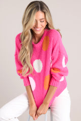 Hot pink polka dot sweater featuring a crew neckline, dropped shoulders, a ribbed hemline and ribbed cuffed long sleeves.