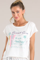 Full front view of this tee that features a crew neckline, a vacation themed graphic, a light & airy material, a slightly cropped length, a split hemline, and short sleeves.
