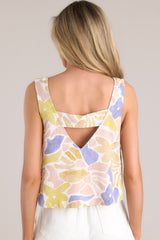 Back view of this crop top that features a square neckline, wide straps, an open back detail, and a unique pattern.