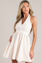 Front view of this dress that features a striped pattern in shades of pink, blue, and yellow.
