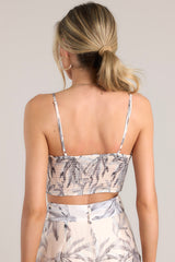Back view of this crop top that features a rounded neckline, thin adjustable straps, a fully smocked back, and a cropped hemline.