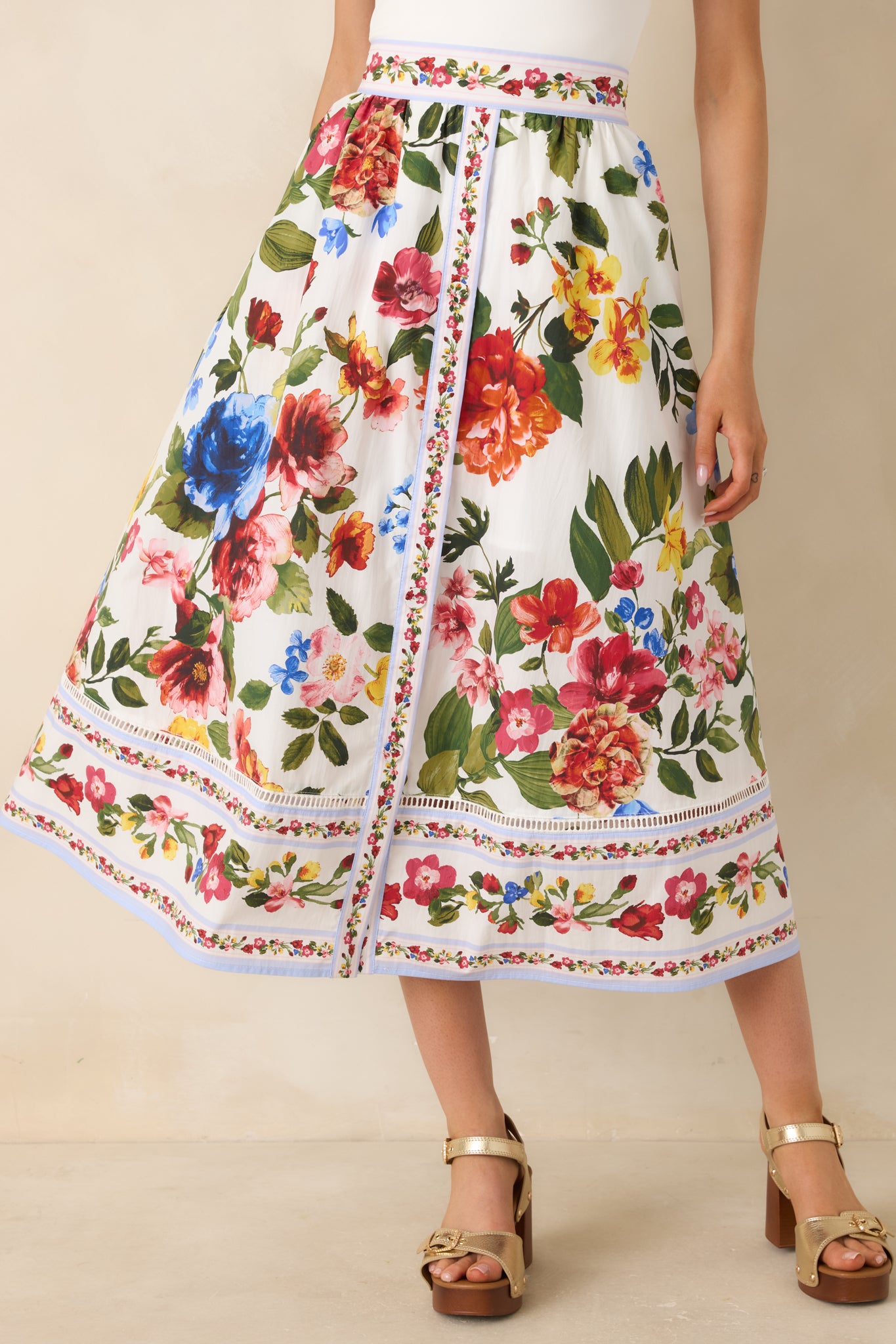 Close view of multi-floral print with detailed hem border design.