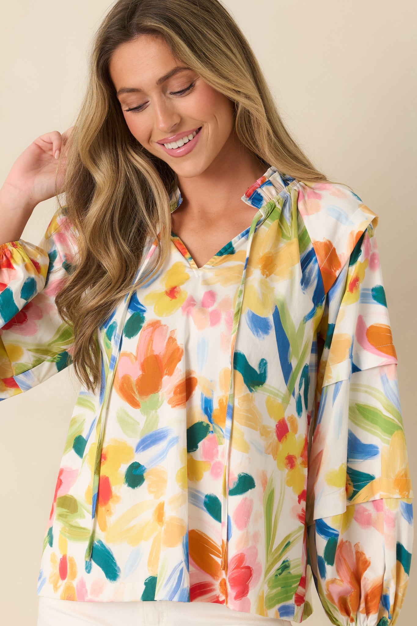 Closer view showing the elastic cuffs and long sleeve shape with floral detailing.