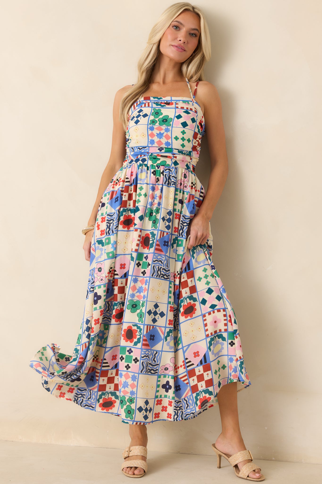 Mixed print maxi dress with fitted ruched bodice and adjustable halter-style straps.
