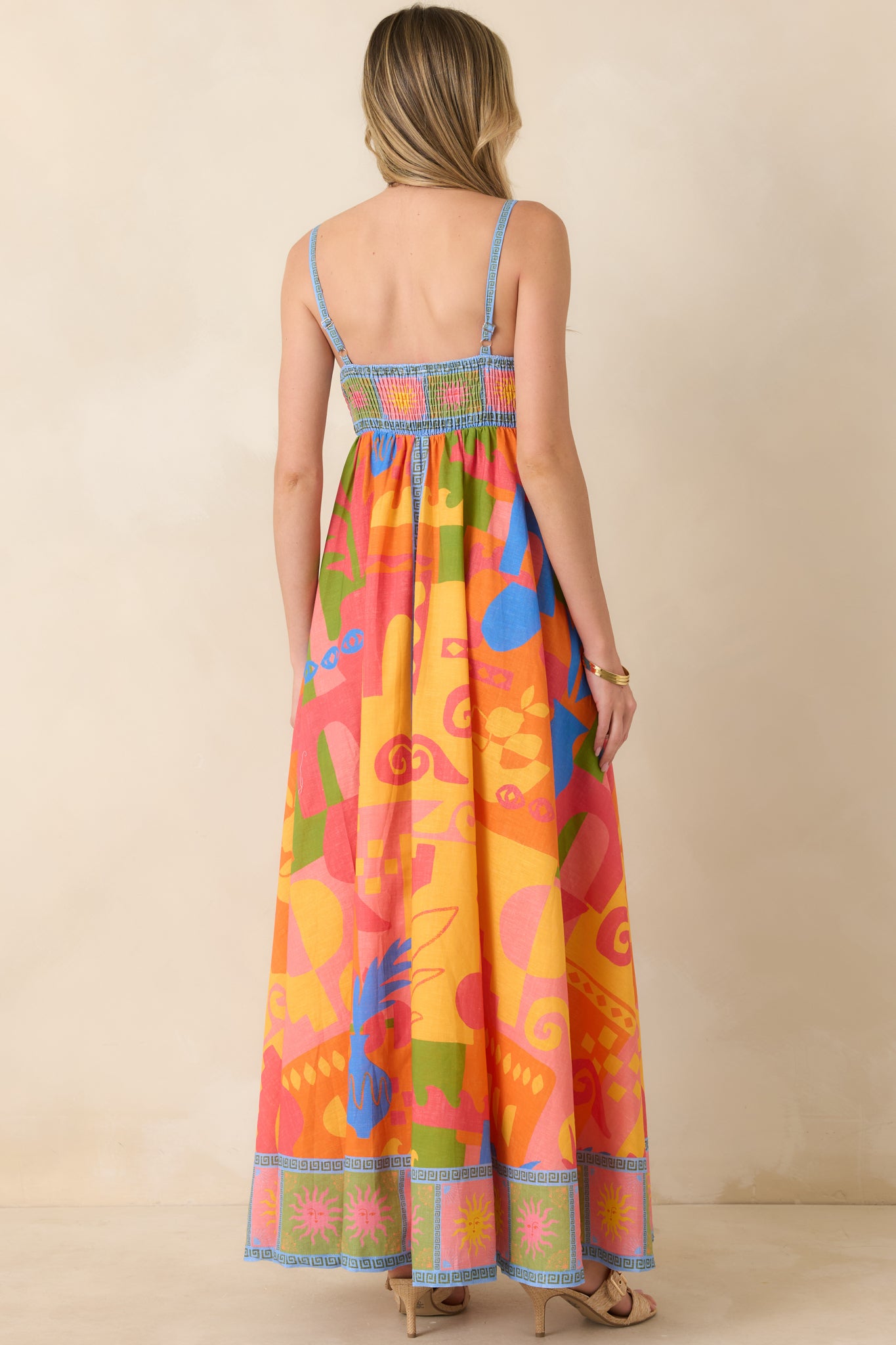 Rear view of maxi dress with adjustable straps and fitted bodice design.