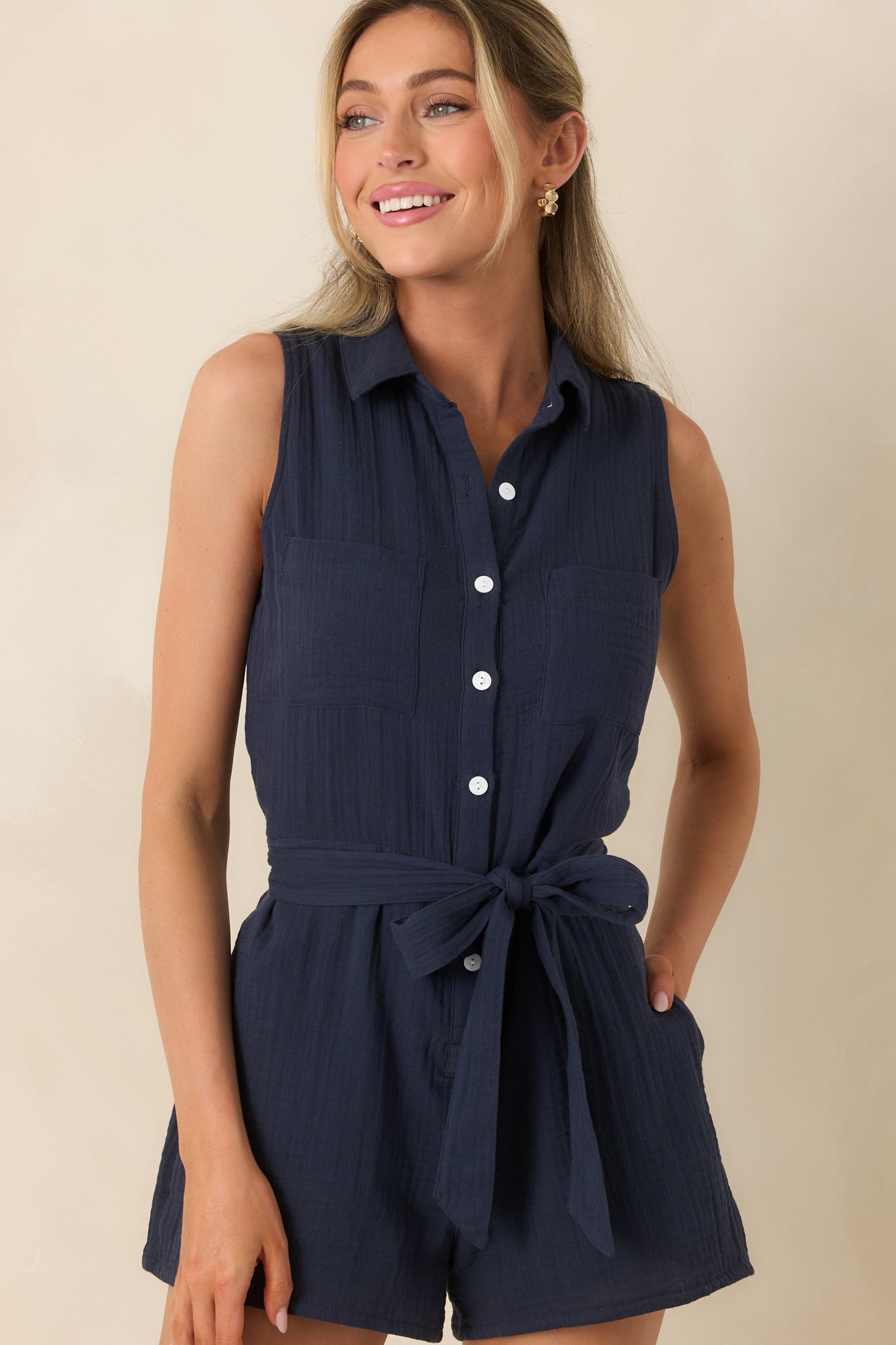 Classic collared neckline and button-front detail on gauze romper.