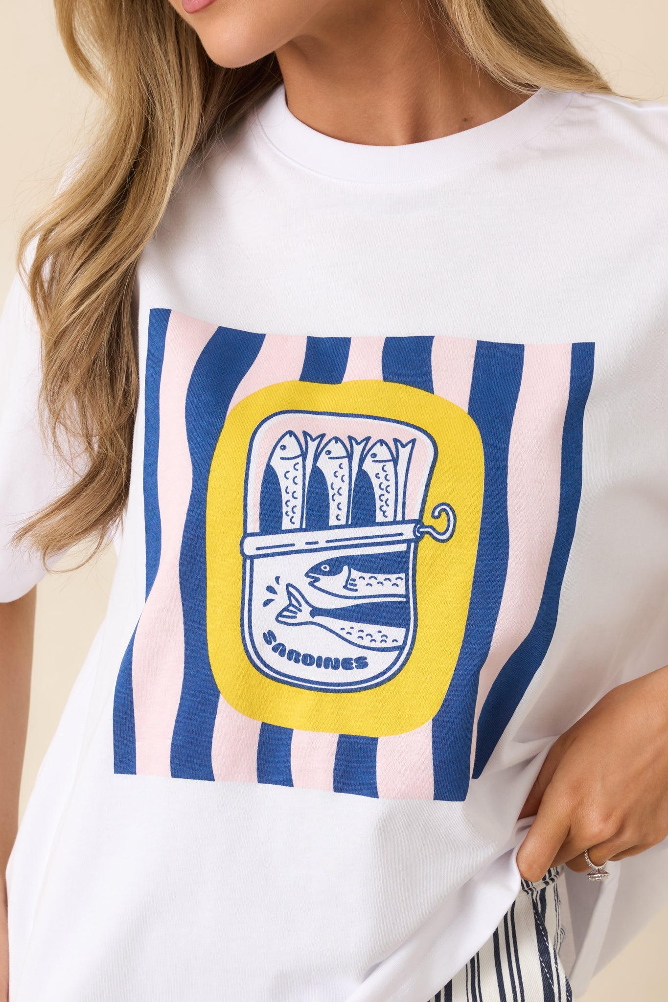 Close-up of bold graphic and striped detailing on white cotton tee.